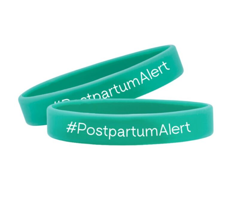 Photo of two teal, rubber wristbands that say #PostpartumAlert
